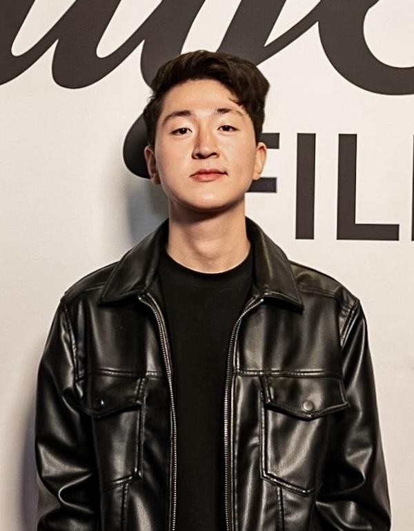 A man wearing a black leather jacket