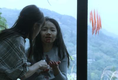 Hsuan-hsuan stands by the window, nose bleeding.